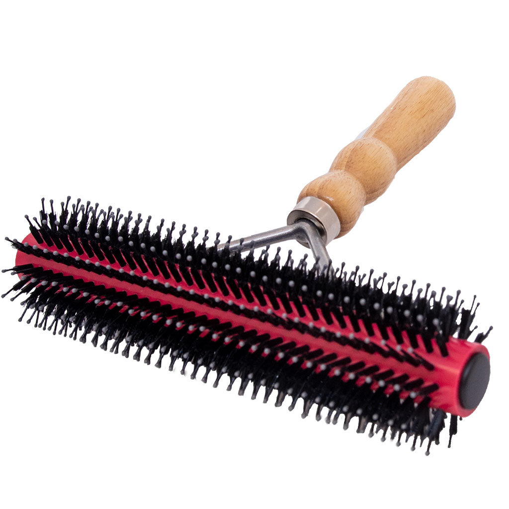 Red and black round brush with wooden handle on a white background
