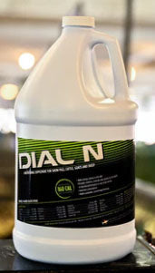 Gallon container of Dial N product on a dark surface with blurred background