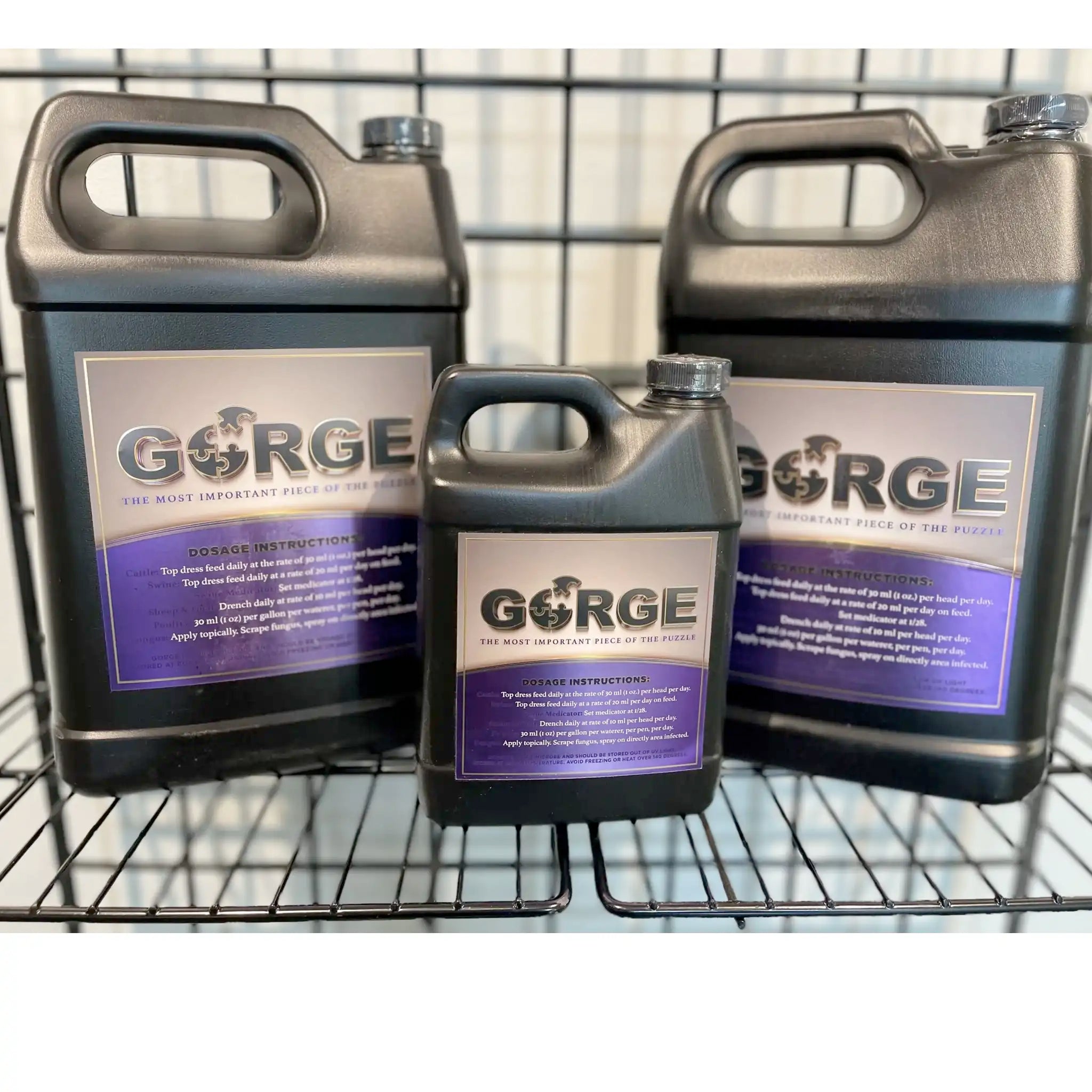 Three GORGE containers on a metal rack with a blurred background