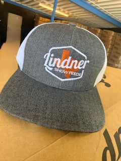 Gray cap with a logo on a cardboard surface
