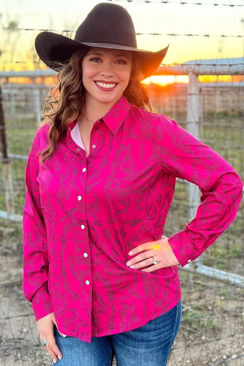 Woman wearing a pink patterned shirt and black cowboy hat with a sunset in the background.