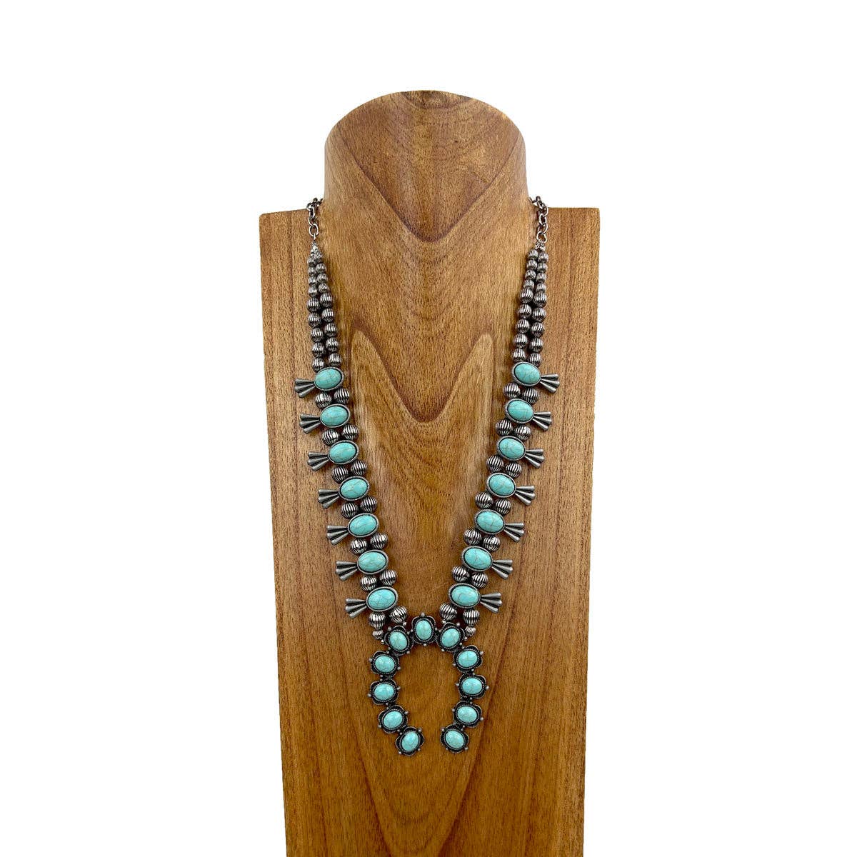 Turquoise beaded necklace on a wooden mannequin