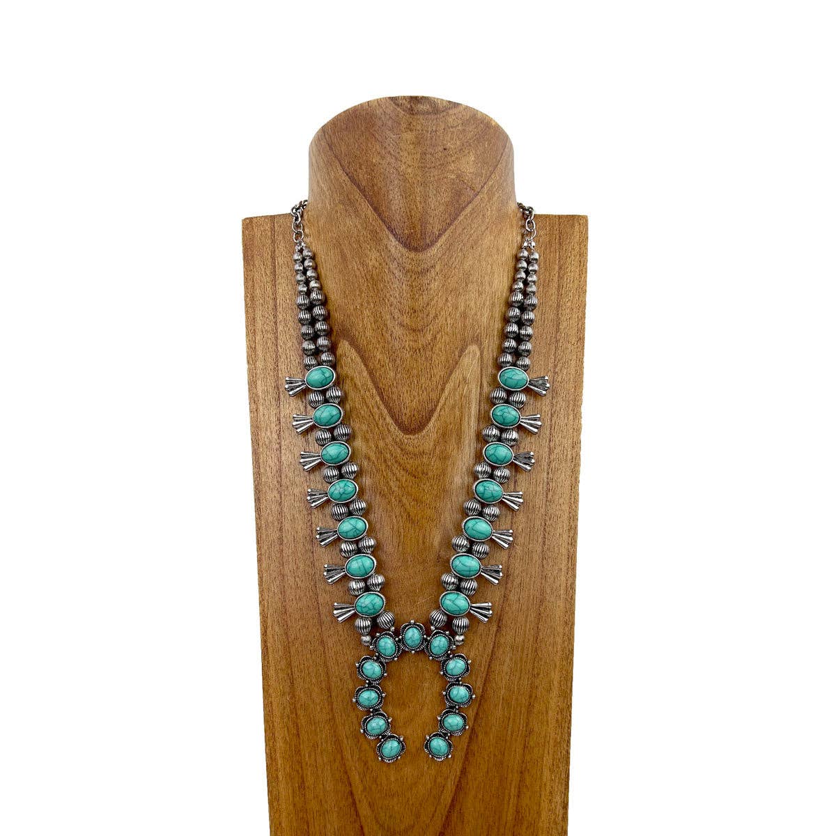 Turquoise beaded necklace on a wooden stand with a white background