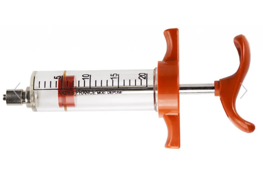 Syringe with orange plunger on a white background