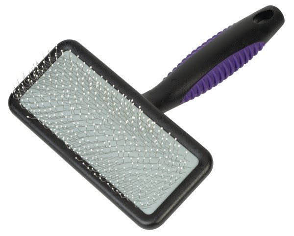 Pet grooming brush with purple handle on a white background