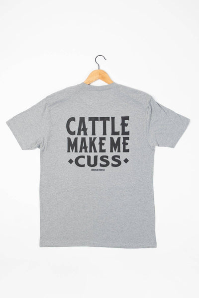 Gray t-shirt with text 'CATTLE MAKE ME CUSS' on a white background