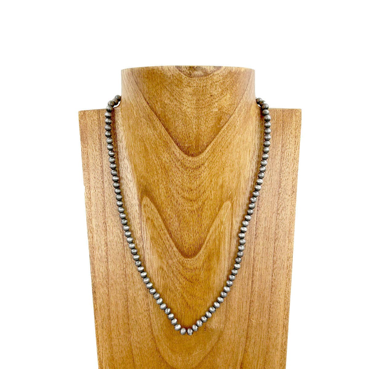 Necklace on a wooden mannequin head with a white background