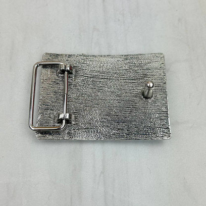 Silver belt buckle on a light gray background