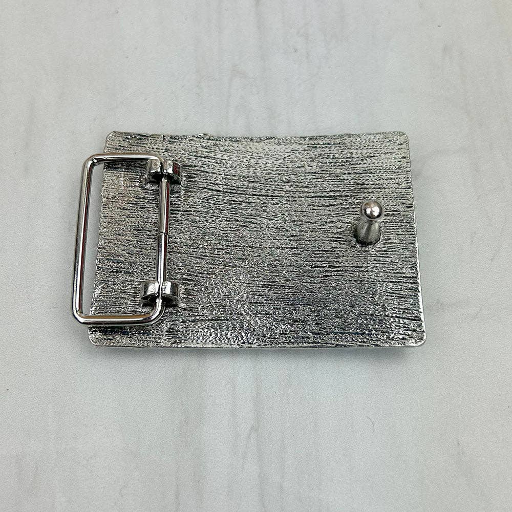 Silver belt buckle on a light gray background