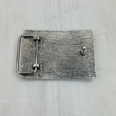 Silver belt buckle on a light gray background