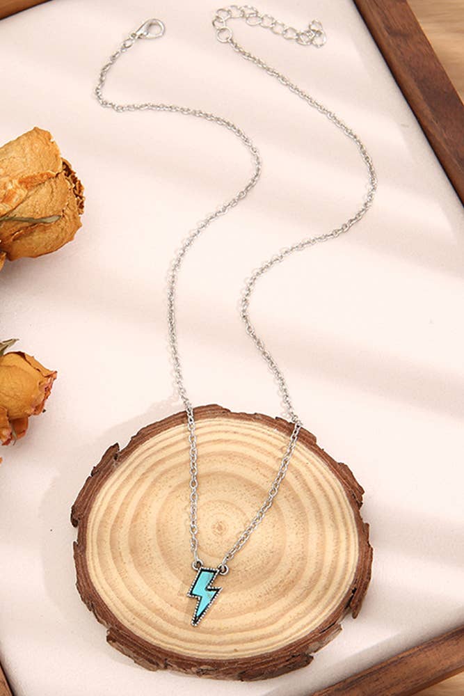 Necklace with a blue pendant on a wooden surface