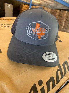 Blue cap with a logo on a cardboard box