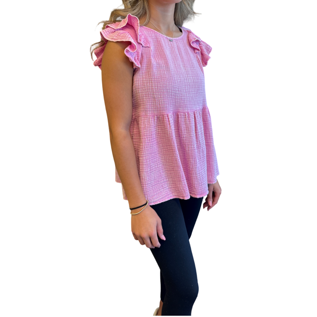 A pink and white gingham check sleeveless top with ruffled shoulder details, modeled on a person wearing black leggings against a plain white background.