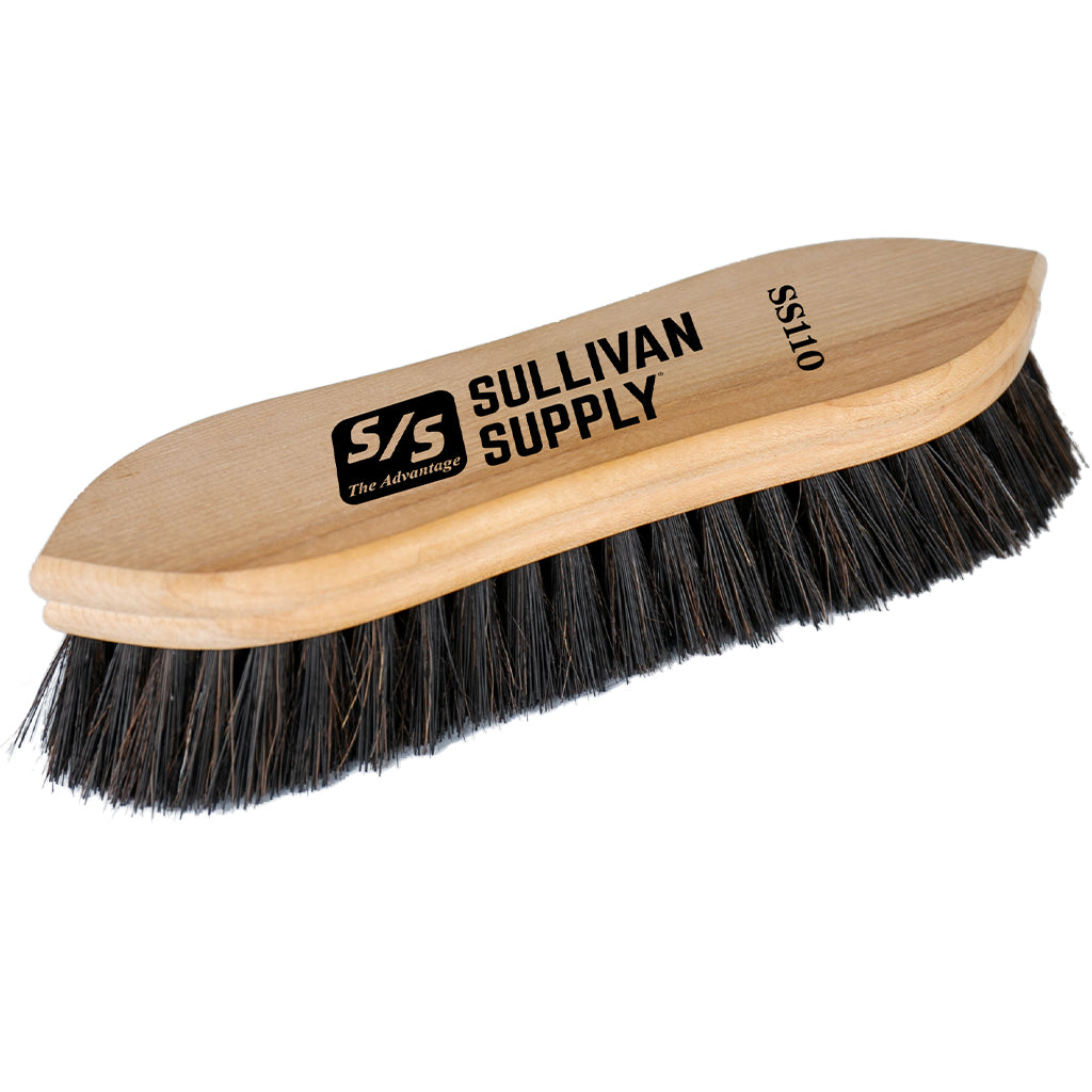 Wooden brush with black bristles and 'Sullivan Supply' branding on a white background