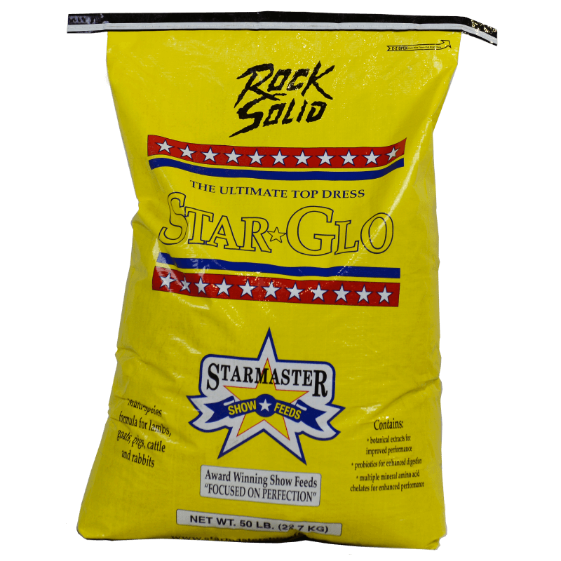 Yellow bag of Star-Glo top dress with branding on a black background