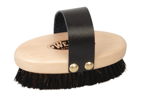 Wooden brush with black bristles and a leather strap on a white background