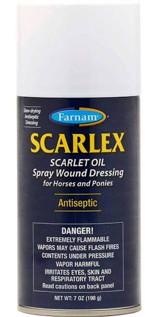 A can of Farnam Scarlet Oil Spray Wound Dressing for horses and ponies, featuring a dark navy blue label with yellow and white text, and a white cap.