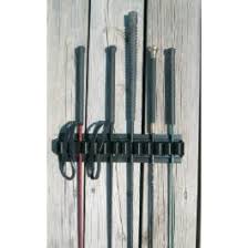 A black wall-mounted sword rack holding several swords against a light gray weathered wood panel background.